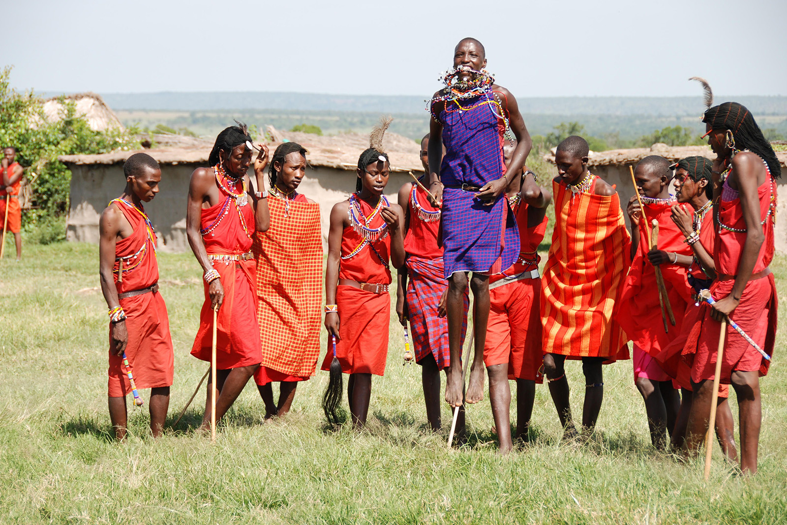 Maasai community members wearing traditional colorful clothing in a cultural village in Kenya