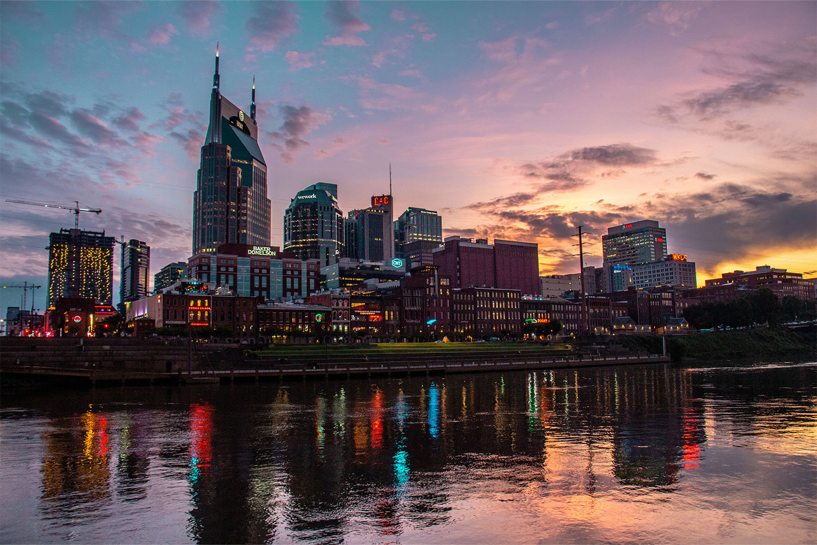 Nashville Tennessee skyline and vibrant Broadway entertainment district illuminated with colorful neon lights