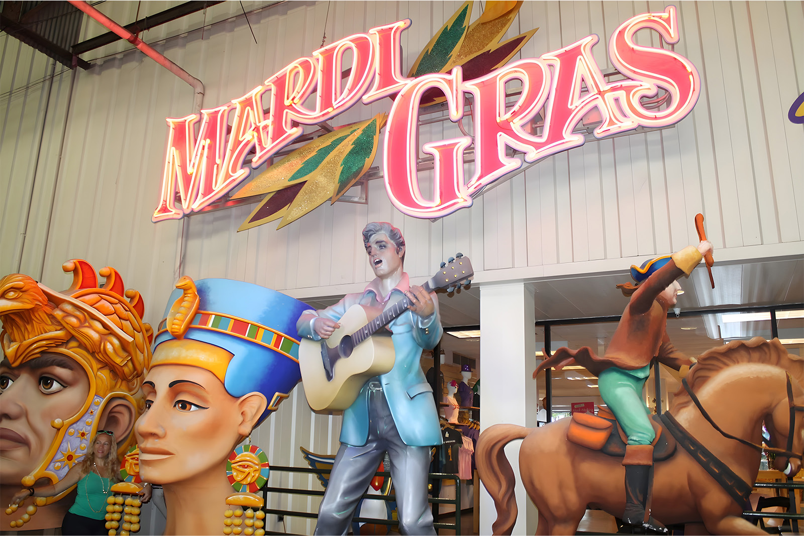 Colorful Mardi Gras parade floats and elaborate decorations displayed at Mardi Gras World in New Orleans