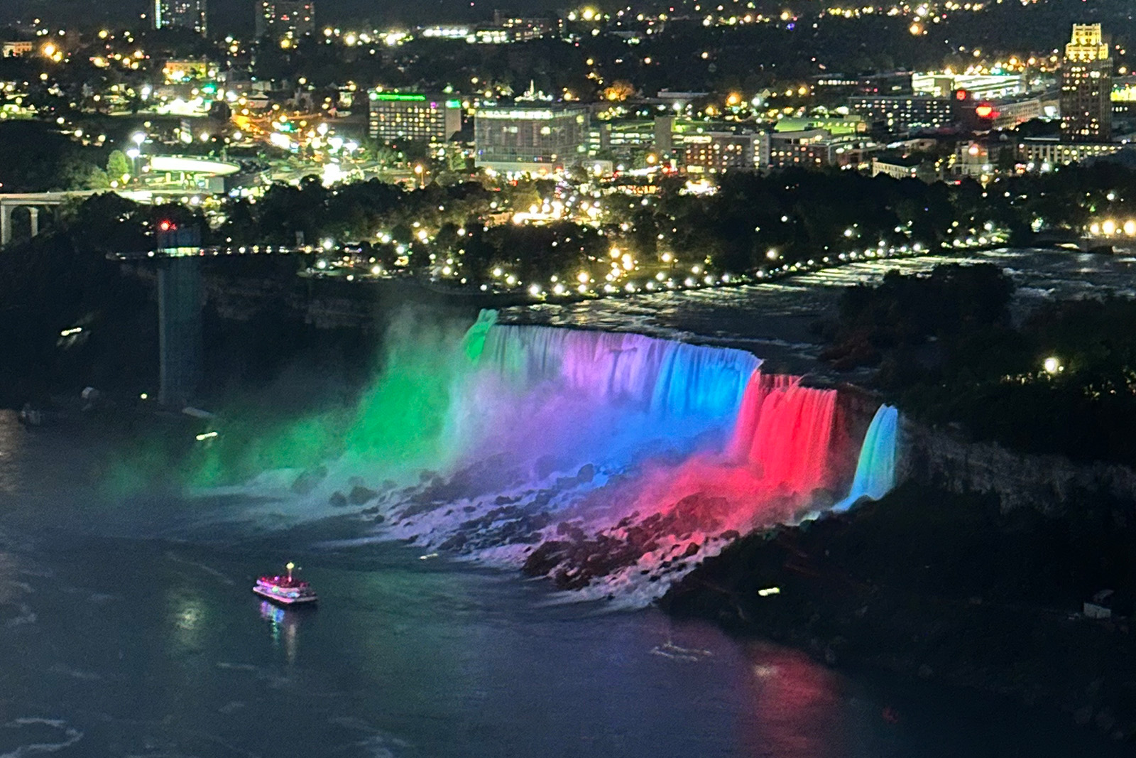 Niagara Falls illuminated with beautiful colorful lights after sunset in Ontario Canada