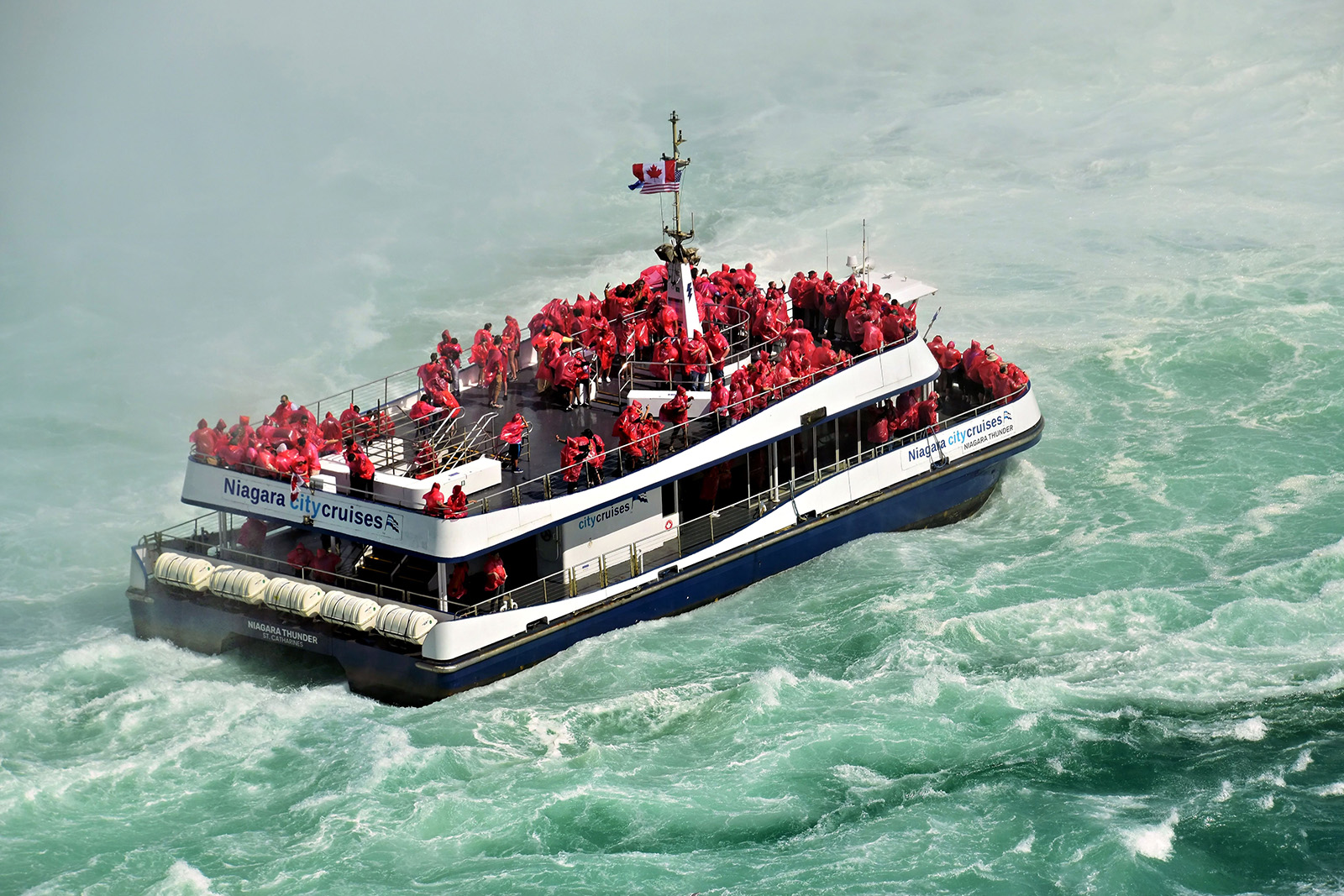 Niagara Falls sightseeing cruise boat carrying visitors toward the spectacular Horseshoe Falls through the mist