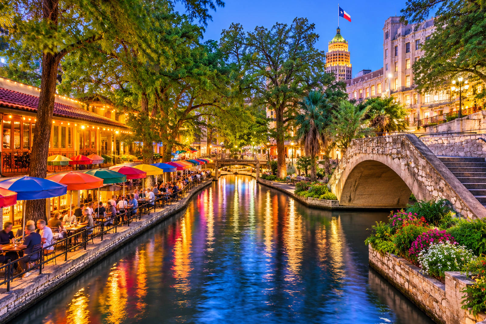 Beautiful San Antonio River Walk in Texas featuring scenic waterways, stone bridges, riverside restaurants and lush greenery