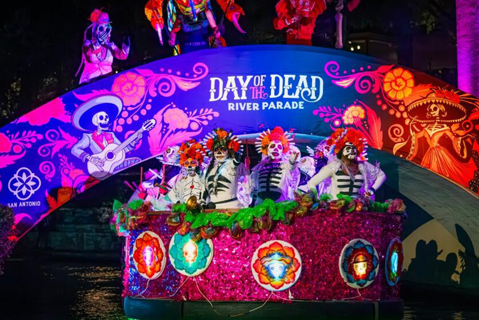 Colorful Muertos Fest celebration in San Antonio Texas featuring traditional Dia de Los Muertos costumes, music, flowers and cultural performances
