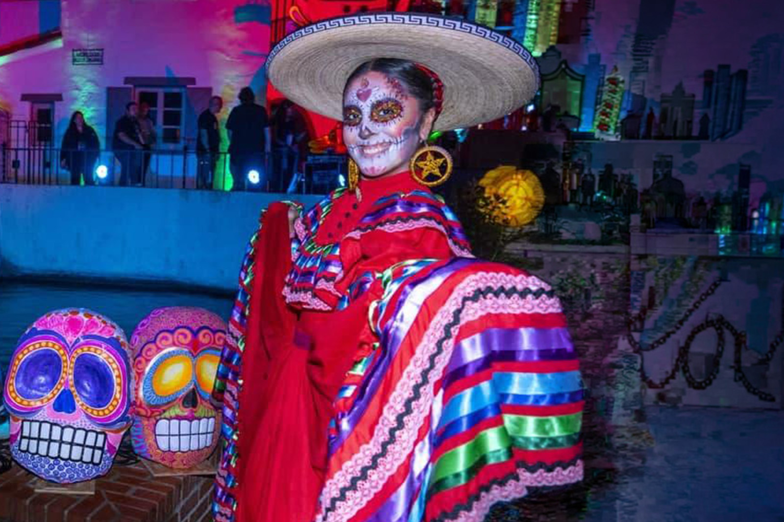 Traditional Mexican folkloric dancers performing in colorful dresses during a Dia de Los Muertos cultural celebration in San Antonio