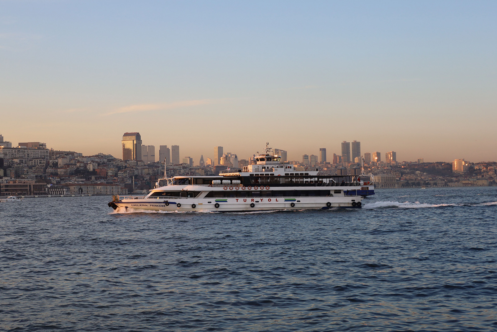 Scenic Bosphorus cruise with waterfront palaces, bridges and Istanbul skyline in Turkey