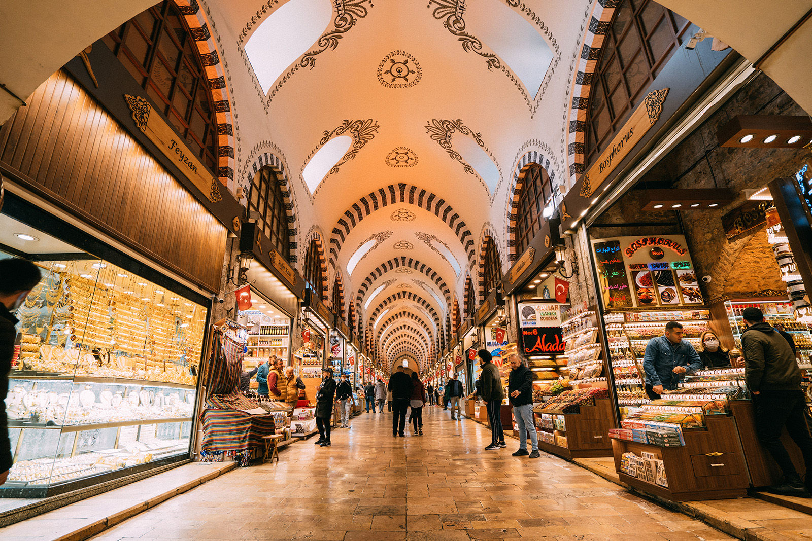 Colorful traditional shops selling Turkish lamps, carpets and souvenirs inside Istanbul Grand Bazaar