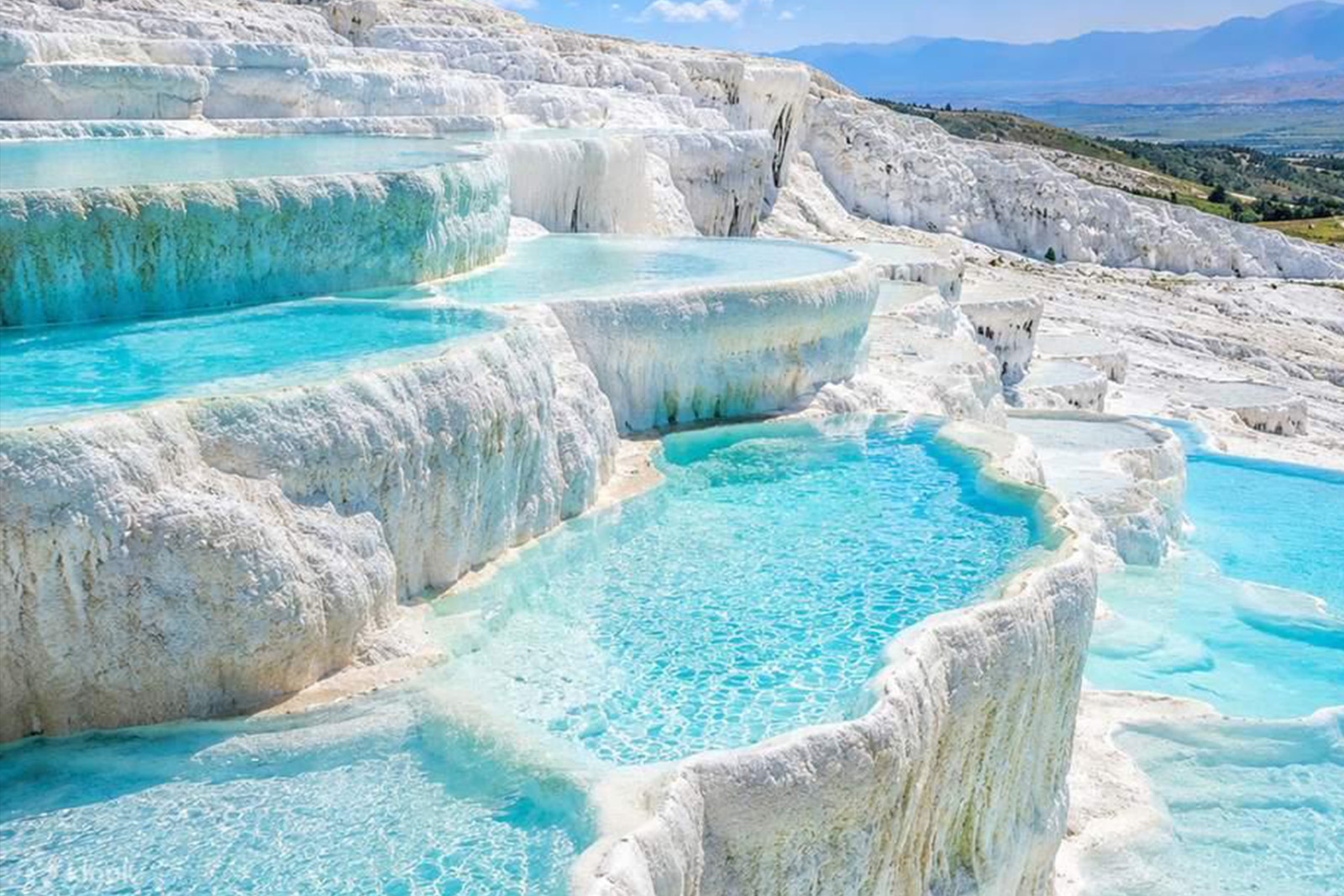 Spectacular white travertine terraces and turquoise thermal pools at Pamukkale Turkey
