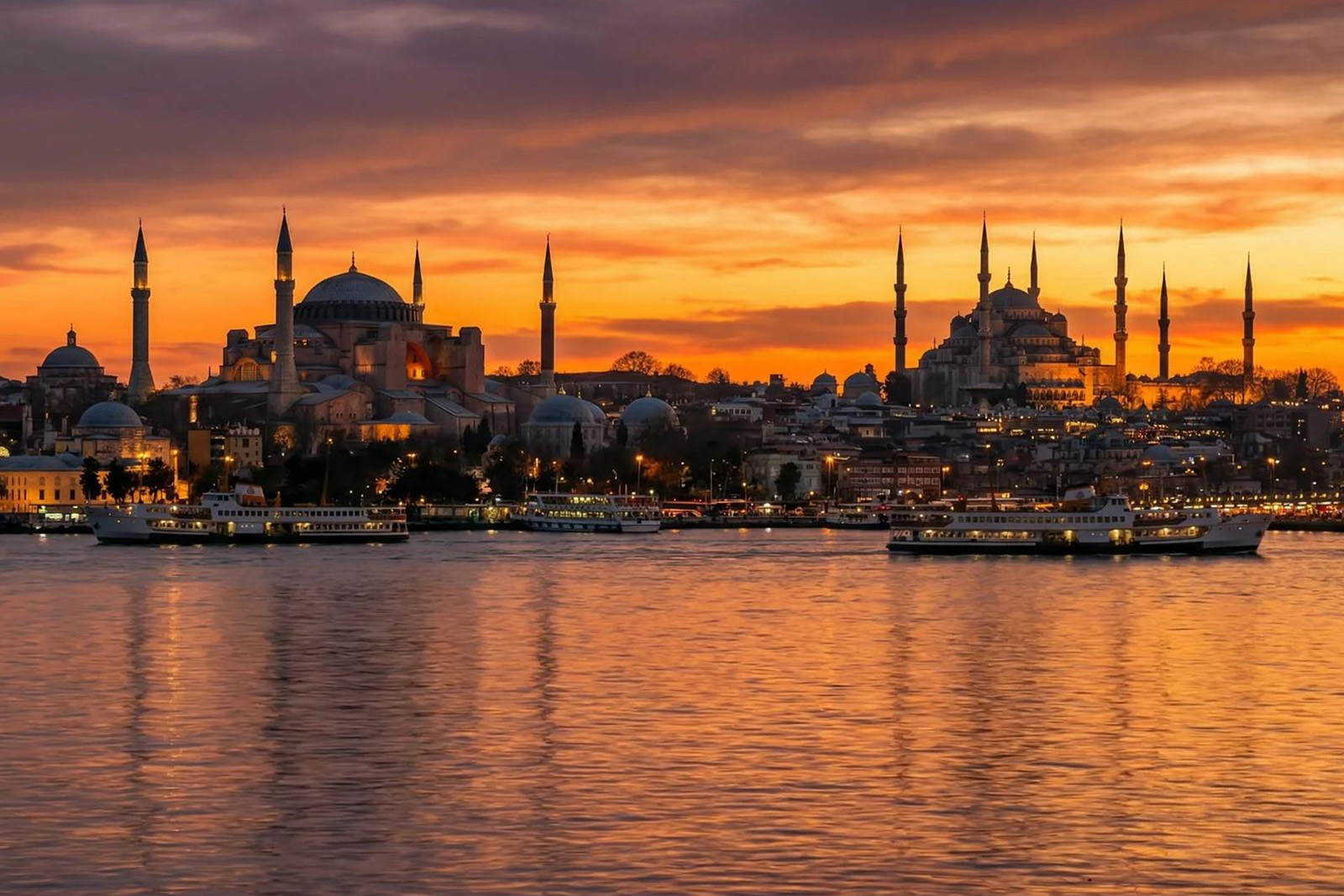 Golden sunset over Istanbul skyline with historic mosque domes, minarets and Bosphorus waterfront