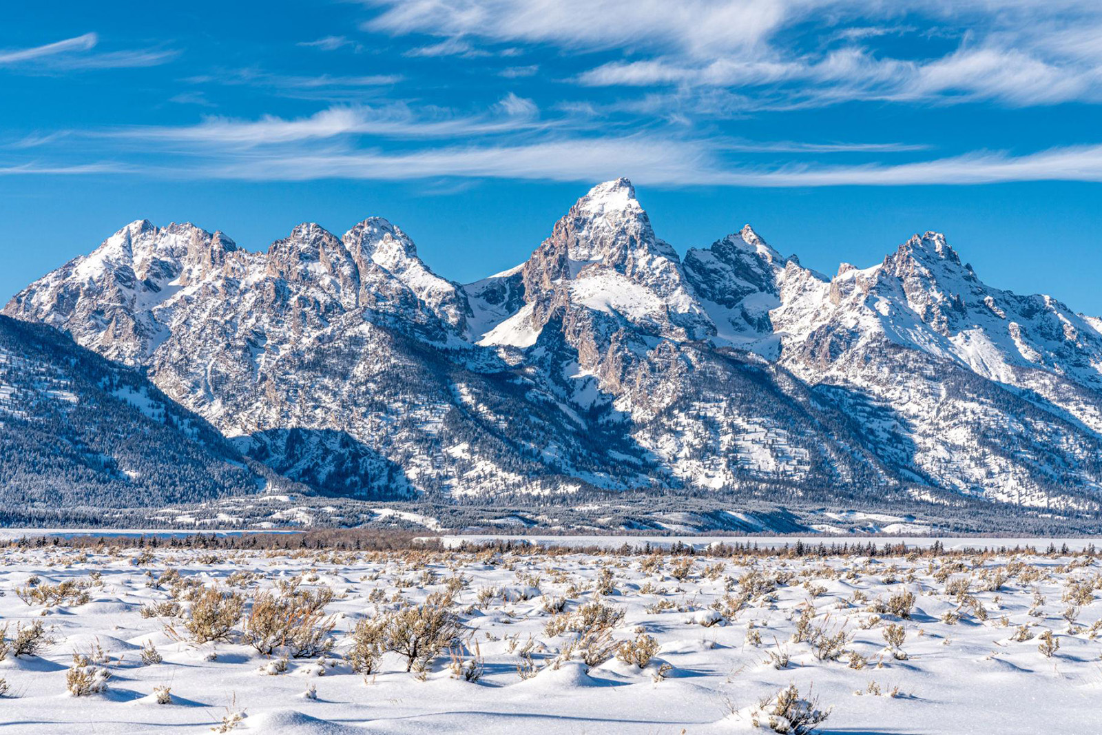 Spectacular snow-covered Grand Teton mountain range and pristine winter landscape in Wyoming