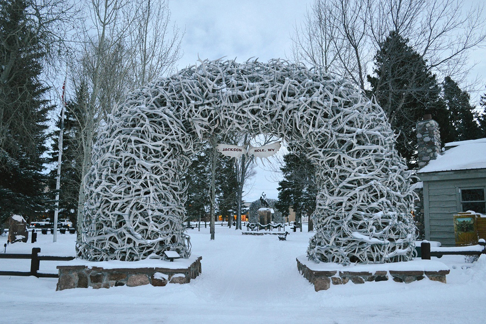Historic Jackson Hole Town Square decorated for winter with famous elk-antler arches and snow-covered streets